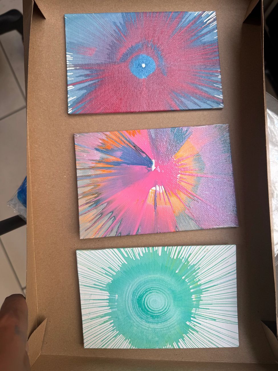 Three finished spin-art canvases